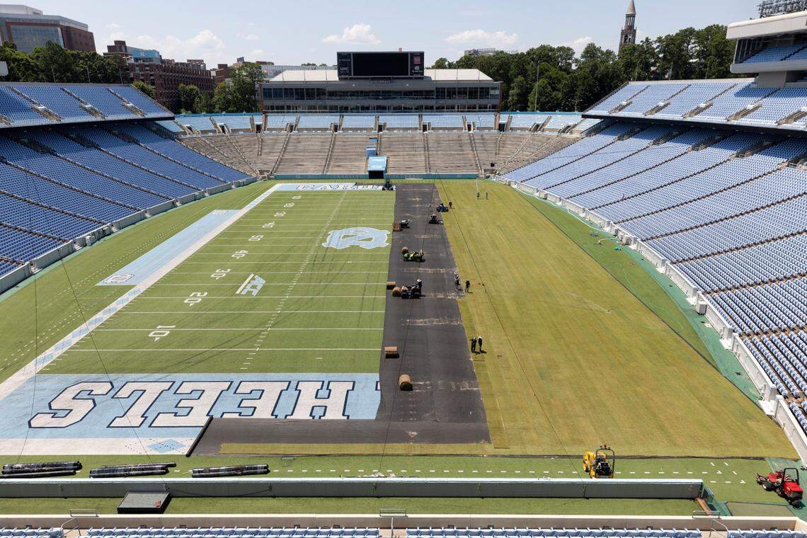 Crews from Carolina Green and the University of North Carolina Turf Management install nearly 100,000 square feet of fresh sod atop the artificial turf in Kenan Stadium in preparation for the FC Series game between Chelsea and Wrexham on Wednesday, July 12, 2023 in Chapel Hill, N.C. The Bermuda 419 sod was grown in Indian Trail, N.C., is 1.5 inches thick, and was installed upon a layer of geo-textile base over the artificial turf, which will be removed following the soccer match on July 19, 2023.