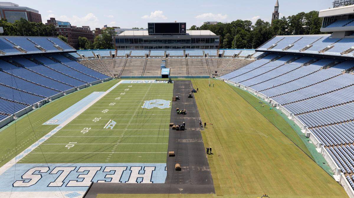Crews from Carolina Green and the University of North Carolina Turf Management install nearly 100,000 square feet of fresh sod atop the artificial turf in Kenan Stadium in preparation for the FC Series game between Chelsea and Wrexham on Wednesday, July 12, 2023 in Chapel Hill, N.C. The Bermuda 419 sod was grown in Indian Trail, N.C., is 1.5 inches thick, and was installed upon a layer of geo-textile base over the artificial turf, which will be removed following the soccer match on July 19, 2023.