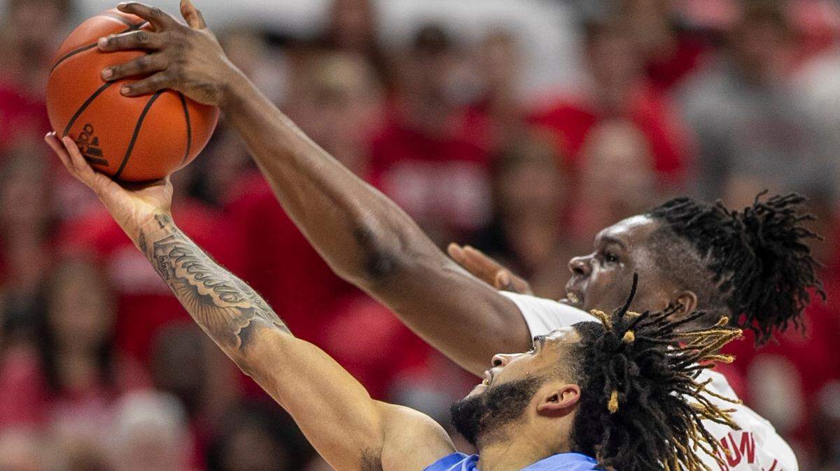 N.C. State’s D.J. Burns (30) blocks a shot by North Carolina’s R.J. Davis (4) during the second half on Sunday, February 19, 2023 at PNC Arena in Raleigh, N.C.