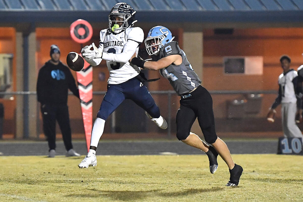 Heritage running back LaDainian Person (3) misses the pass while defended by Cleveland’s Braxton Lowe (34) during the first half. The Cleveland Rams and the Heritage Huskies met in the first round of the NCHSAA 4A playoffs in Clayton, N.C. on November 15, 2024.