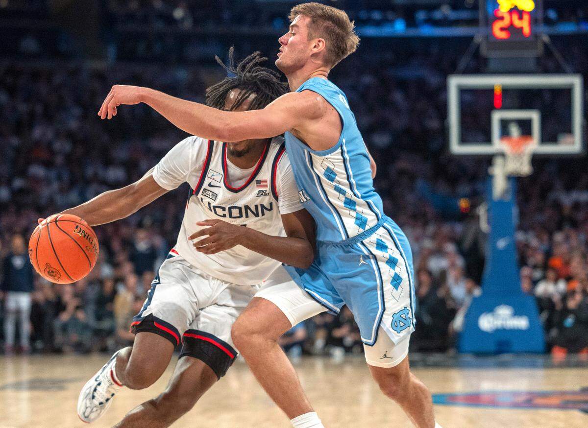 North Carolina’s Paxson Wojcik (8) defends Connecticut’s Tristen Newton (2) during the first half in the Jimmy V Classic on Tuesday, December 5, 2023 at Madison Square Garden in New York, NY.