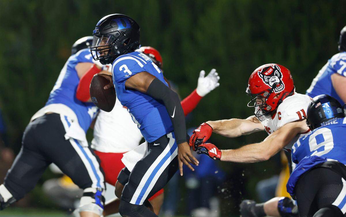 Duke quarterback Henry Belin IV (3) gets away from N.C. State linebacker Payton Wilson (11) during the first half of N.C. State’s game against Duke at Wallace Wade Stadium in Durham, N.C., Saturday, Oct. 14, 2023.