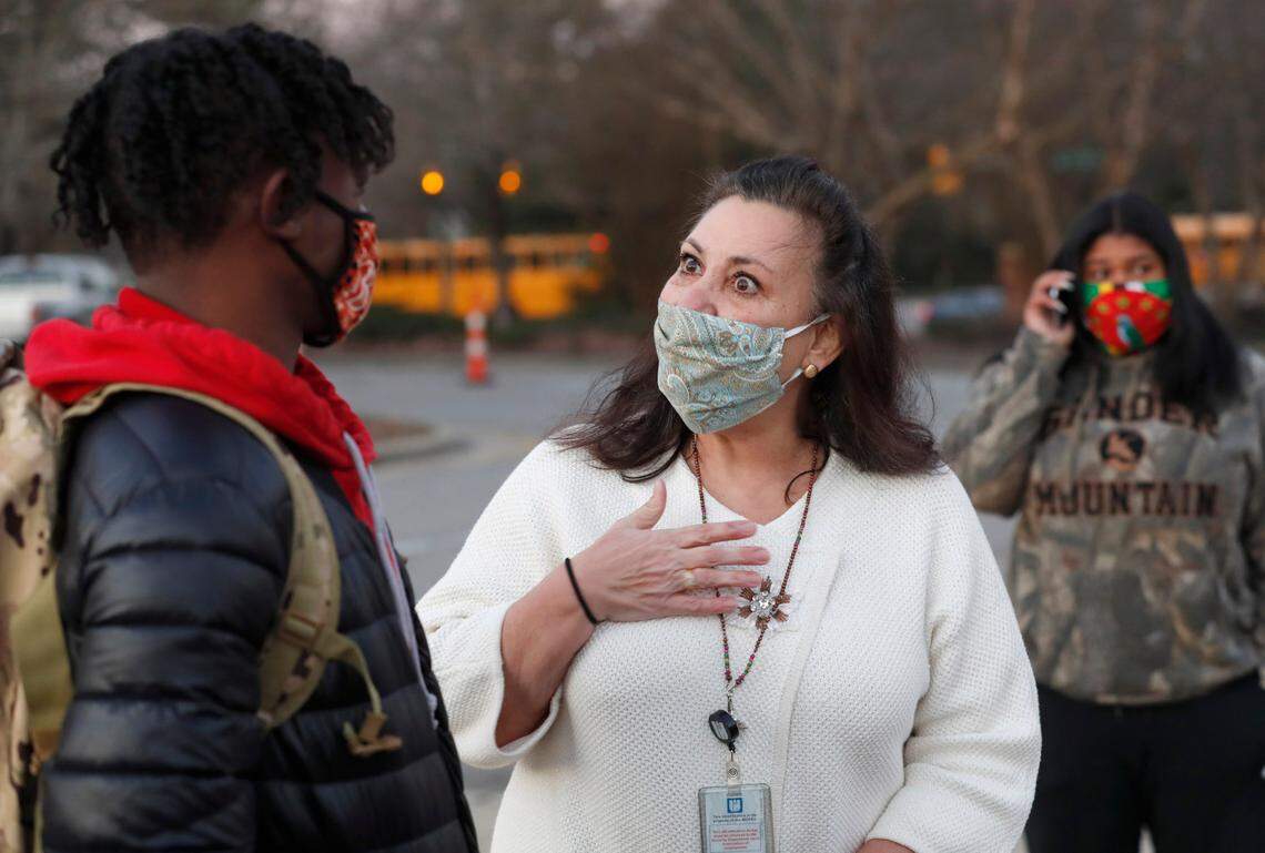 Millbrook High School principal Dana King talks with students, including Jaedyn Thomas, outside the school in Raleigh on Feb. 17, 2021.