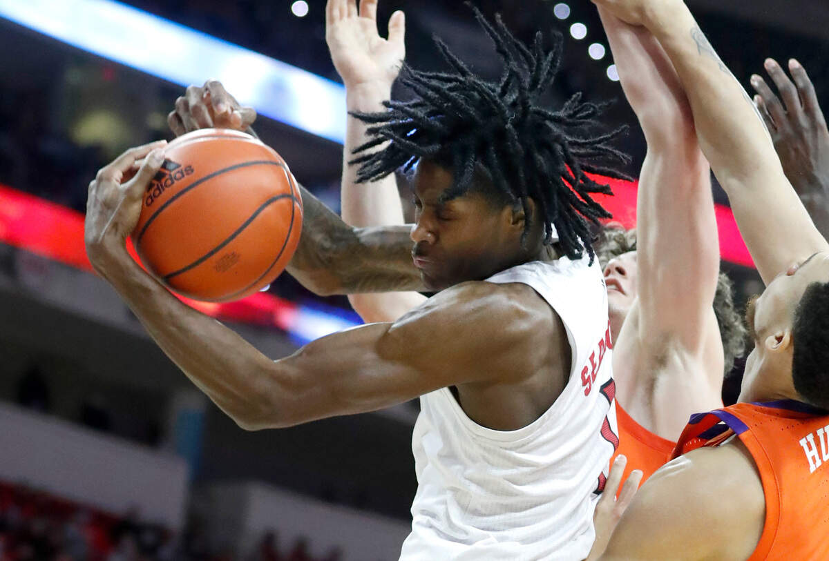 N.C. State’s Dereon Seabron (1) pulls in a rebound during the second half of Clemson’s 70-65 victory over N.C. State at PNC Arena in Raleigh, N.C., Saturday, January 8, 2022.