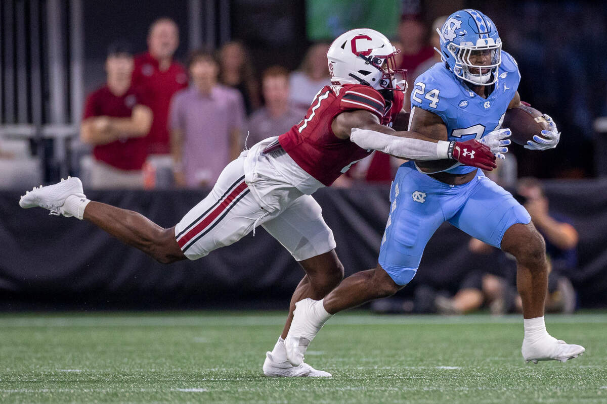 North Carolina running back British Brooks (24) breaks away from South Carolina’s Nick Emmanwori (21) for a 8-yard gain after a pass from quarterback Drake Maye in the first quarter on Saturday September 2, 2023 at Bank of America Stadium in Charlotte, N.C.