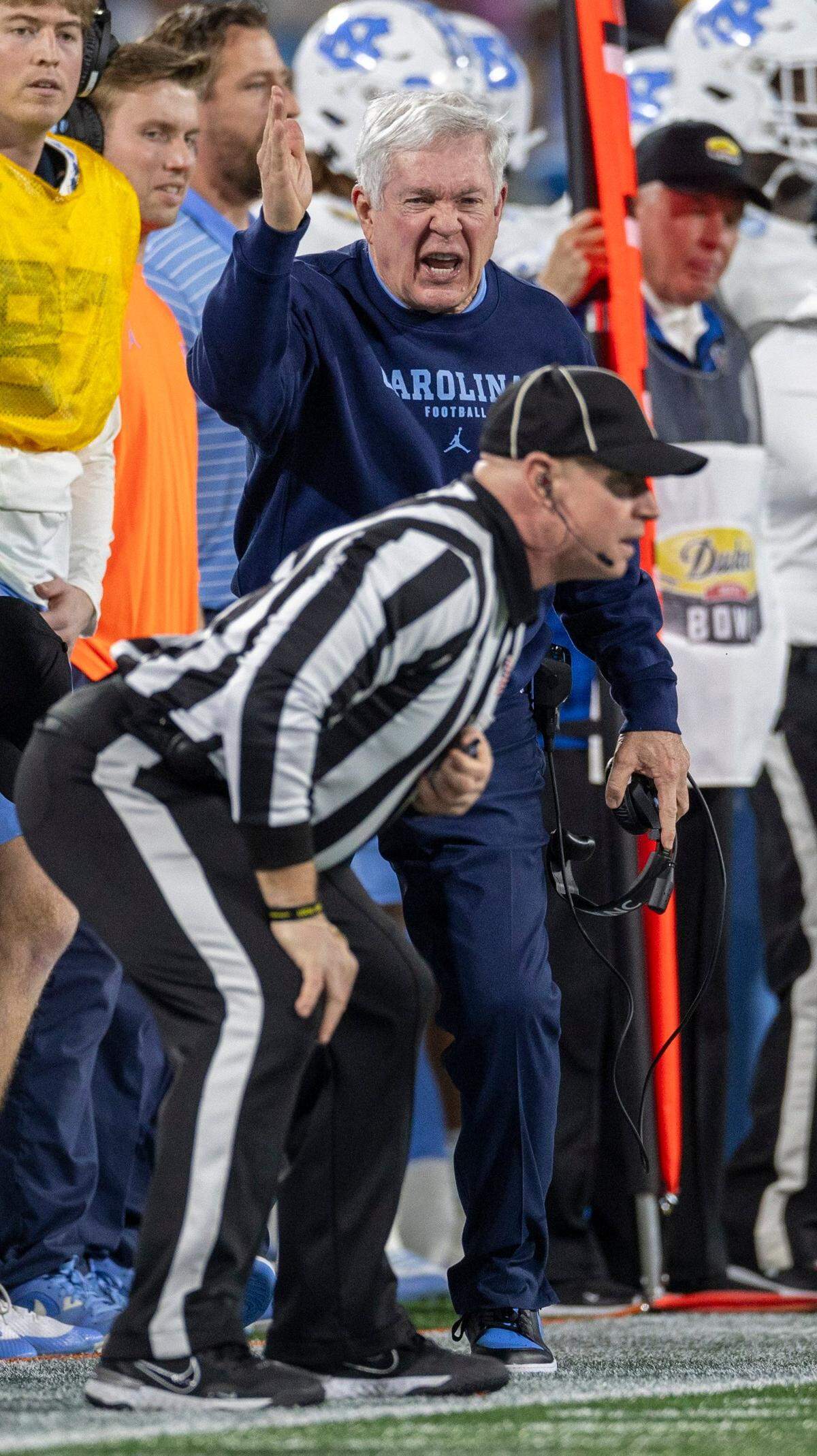 North Carolina coach Mack Brown argues with the official after a penalty against the Tar Heels in the first quarter against West Virginia in the Duke’s Mayo Bowl on Wednesday, December 27, 2023 at Bank of American Stadium in Charlotte, N.C.