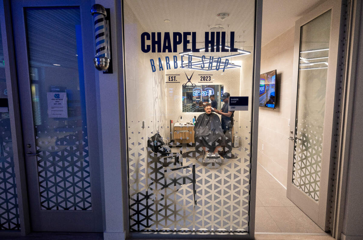 Barber Lionel Poteat works with North Carolina punter Tom Maginess at the team’s barber shop on Tuesday, September 10, 2024 at Kenan Stadium in Chapel Hill, N.C.