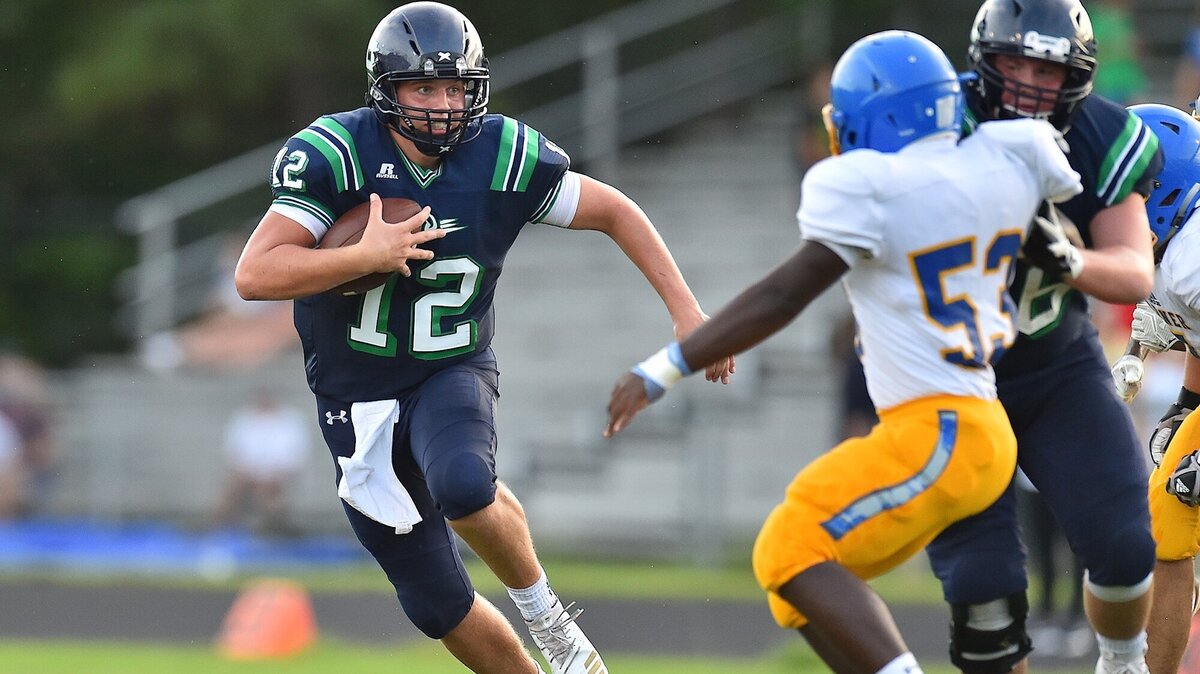 Leesville Road quarterback Vince Amendola (12) scrambles for yardage against the Garner Magnet defense on Sept. 12. The Pride host Cardinal Gibbons on Friday in a showdown of one loss teams.