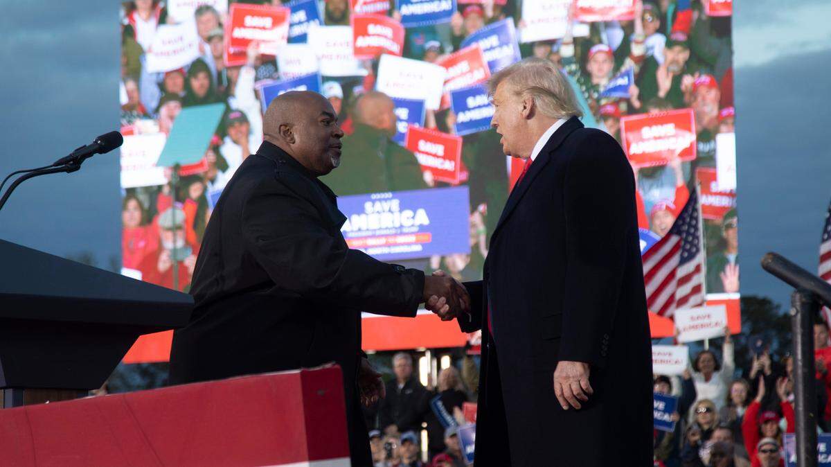 Lt. Gov. Mark Robinson and former President Donald Trump shake hands during a rally in Selma Saturday, April 9, 2022.