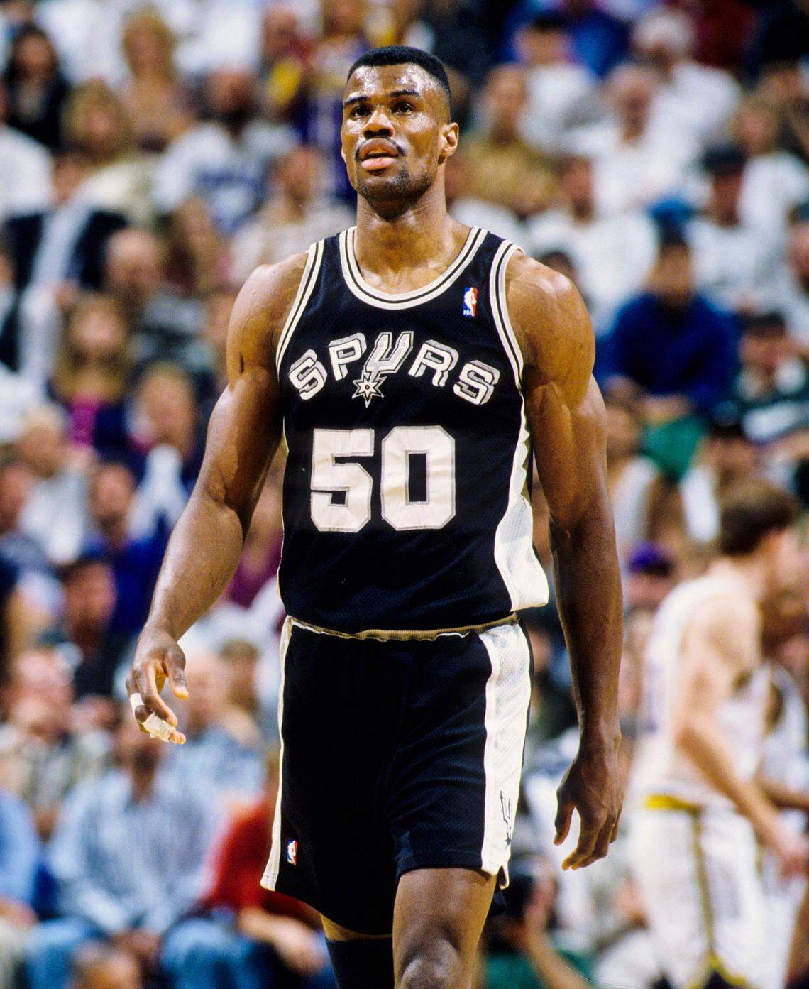 San Antonio Spurs center David Robinson (50) walks on the court during the 1996 season.
