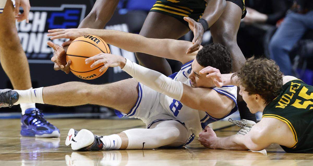 Duke’s Darren Harris (8) tries to control a loose ball as Siena’s Riley Mulvey (55) comes induring the second half of Duke’s 71-65 victory over Siena in the first round of the NCAA Men’s Basketball Tournament at  Bon Secours Wellness Arena in Greenville, S.C., Thursday, March 19, 2026.