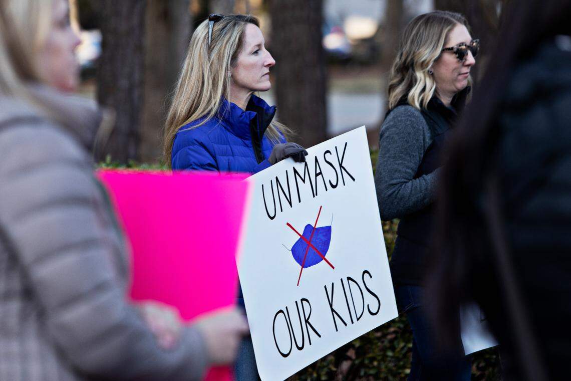 A crowd of around 100 people rallied outside Tuesday’s Wake County school board meeting in Cary Feb. 15, 2022, demanding that the district immediately stop mandating that students wear masks. Event participants want the school board to vote Tuesday or to call a special meeting by next week to vote on making masks optional.