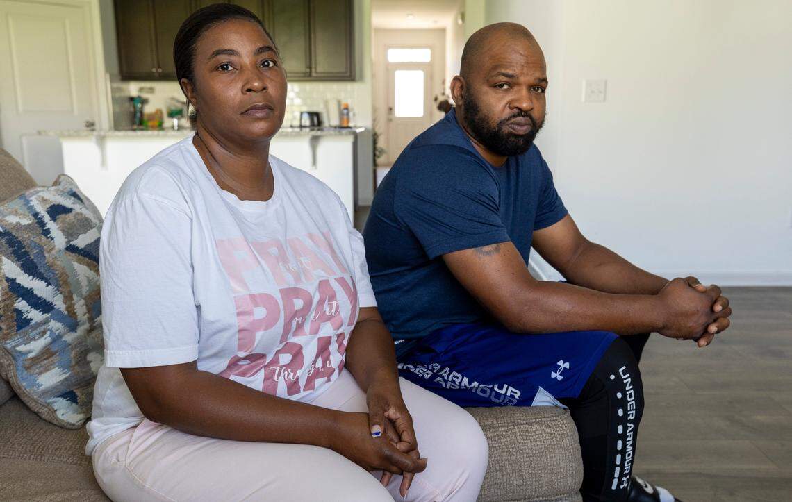 Rotesha McNeil and her husband, Jermaine McNeil, photographed in their home on Aug. 16 in Clayton, N.C. McNeil signed onto a potential class action suit alleging her civil rights were violated when she was arrested on warrants that should have been recalled from the state’s new eCourts system.