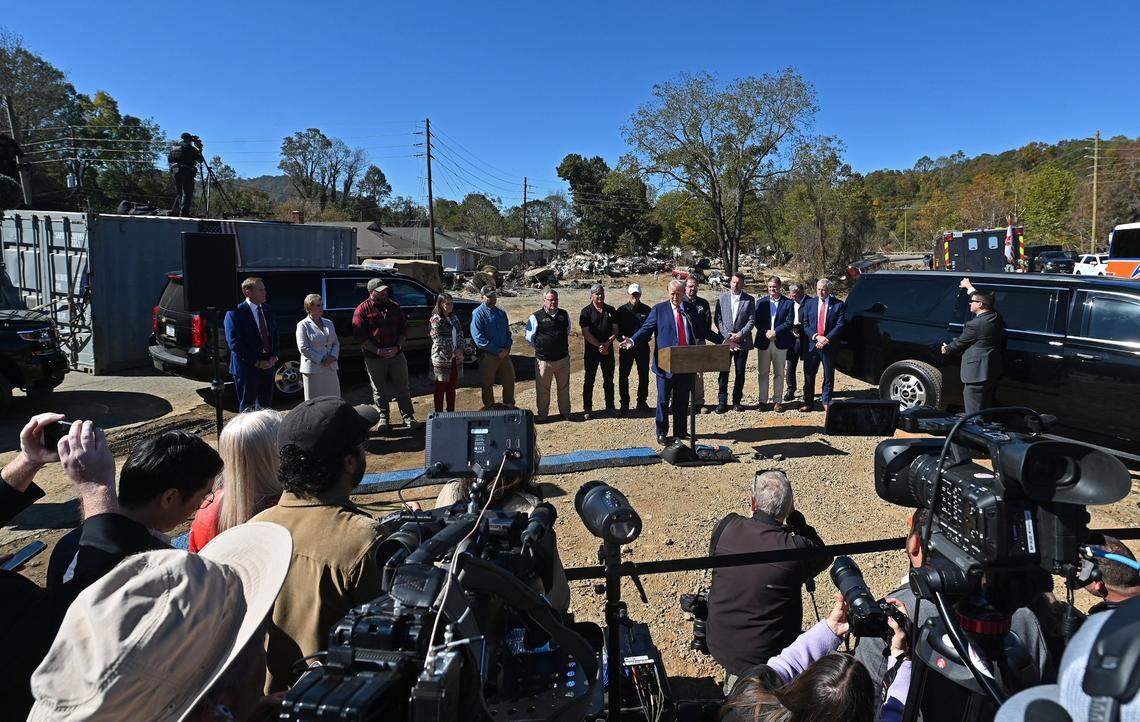 Former President Donald J. Trump, center, addresses the media after touring the Swannanoa, NC area to see the damage caused by Hurricane Helene on Monday, October 21, 2024.