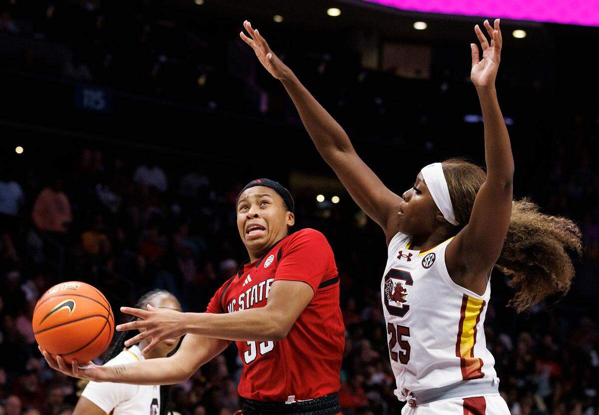 N.C. State’s Zoe Brooks drives to the basket past South Carolina’s Raven Johnson during the second half of the Wolfpack’s 71-57 loss on Sunday, Nov. 10, 2024, at Spectrum Center in Charlotte, N.C.