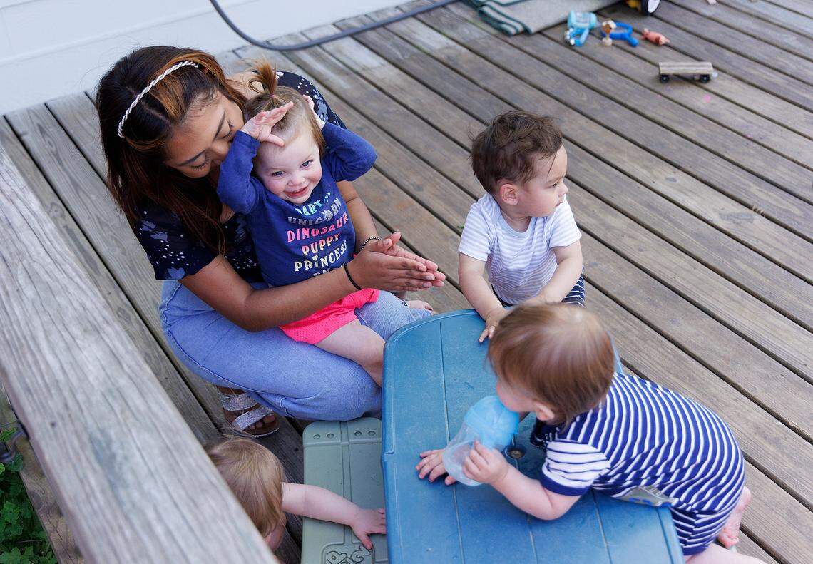 Roxanna Campos-Sosa, a teacher at the Little School of Hillsborough, plays outside with children on Thursday, April 18, 2024, in Hillsborough, N.C.