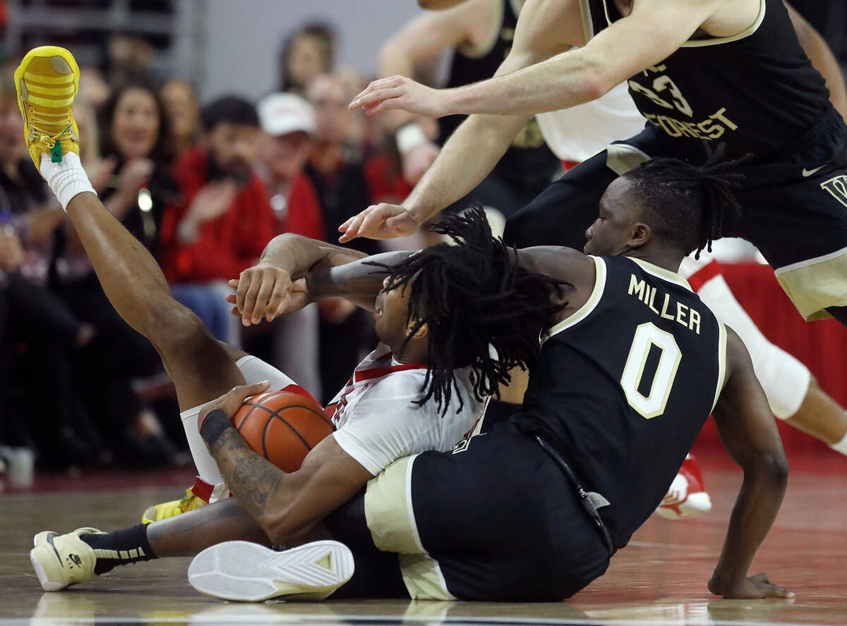 N.C. State’s Jayden Taylor calls a timeout after securing a loose ball away from Wake Forest’s Kevin Miller during the second half of the Wolfpack’s 83-76 win on Tuesday, Jan. 16, 2024, in Raleigh, N.C.