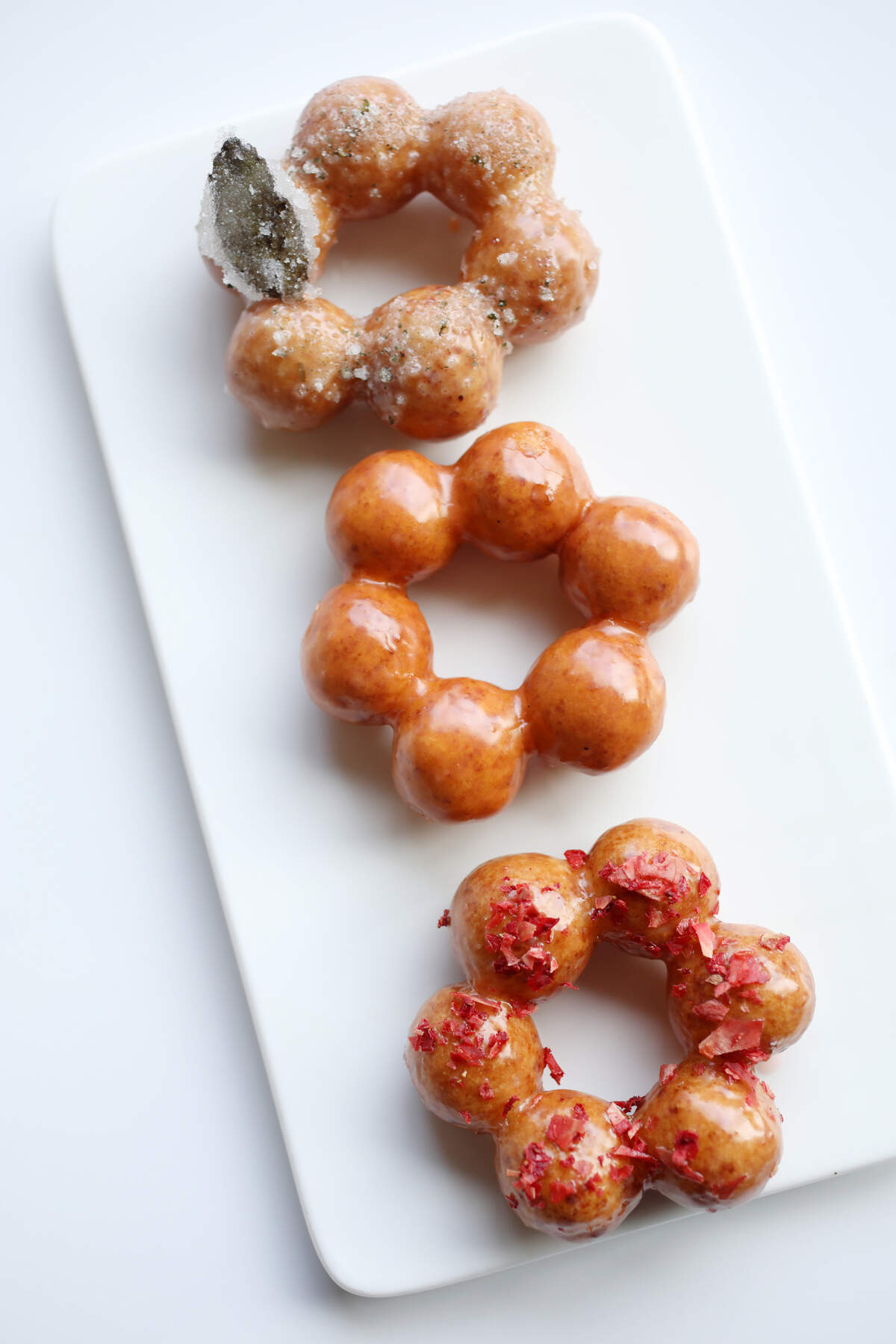 Heirloom Brewshop’s mochi donuts are delicate wreaths of rice flour and tofu pastry, available in three flavors: strawberry-limeade, yuzu mint, and Lao tea glaze.