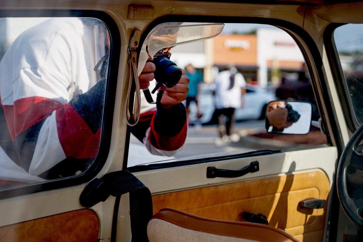 Reporter Richard Stradling reported on a father and son from Apex NC who restored a Trabant. The car, seen here being photographed at a local car show, was a symbol of Cold War communism.