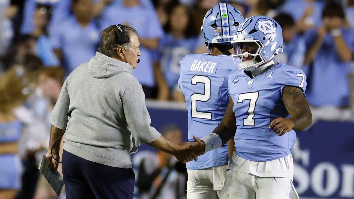 North Carolina head coach Bill Belichick congratulates quarterback Gio Lopez (7) after the Tar Heels scored in the first half of UNC’s game against TCU at Kenan Stadium in Chapel Hill, N.C., Monday, Sept. 1, 2025.