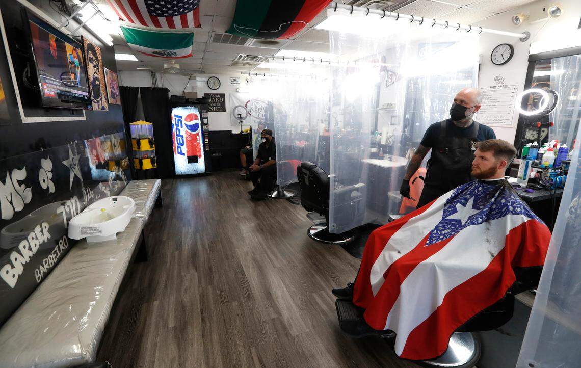 Jesse Padilla, owner of The Right Cut Barber Shop in Cary, N.C., and customer Andrew Bardsley watch as the verdict is read in the trial of Derek Chauvin Tuesday, April 20, 2021. Padilla said he was happy to see the verdict and see Chauvin be held accountable. “It is not the end but a step in the right direction” said Padilla.