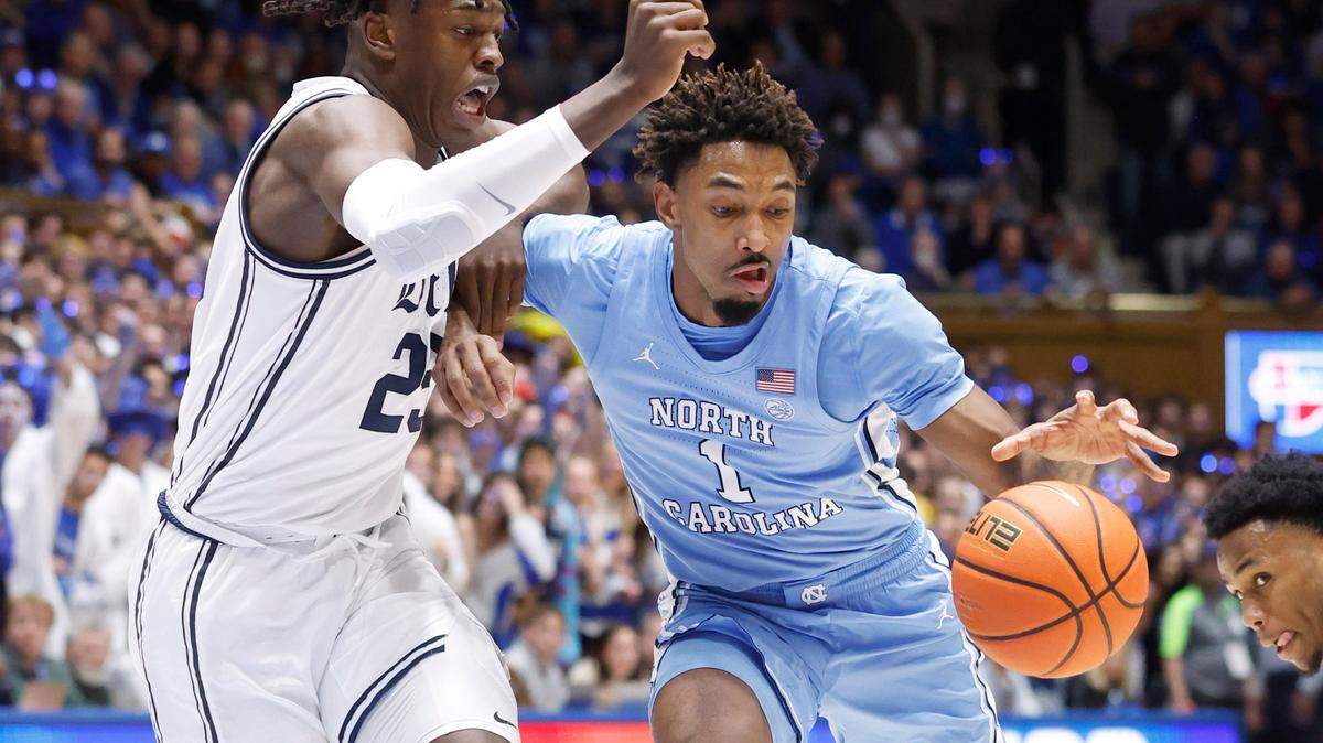 North Carolina’s Leaky Black (1) keeps control of the ball while defended by Duke’s Mark Mitchell (25) during the first half of Duke’s game against UNC at Cameron Indoor Stadium in Durham, N.C., Saturday, Feb. 4, 2023.