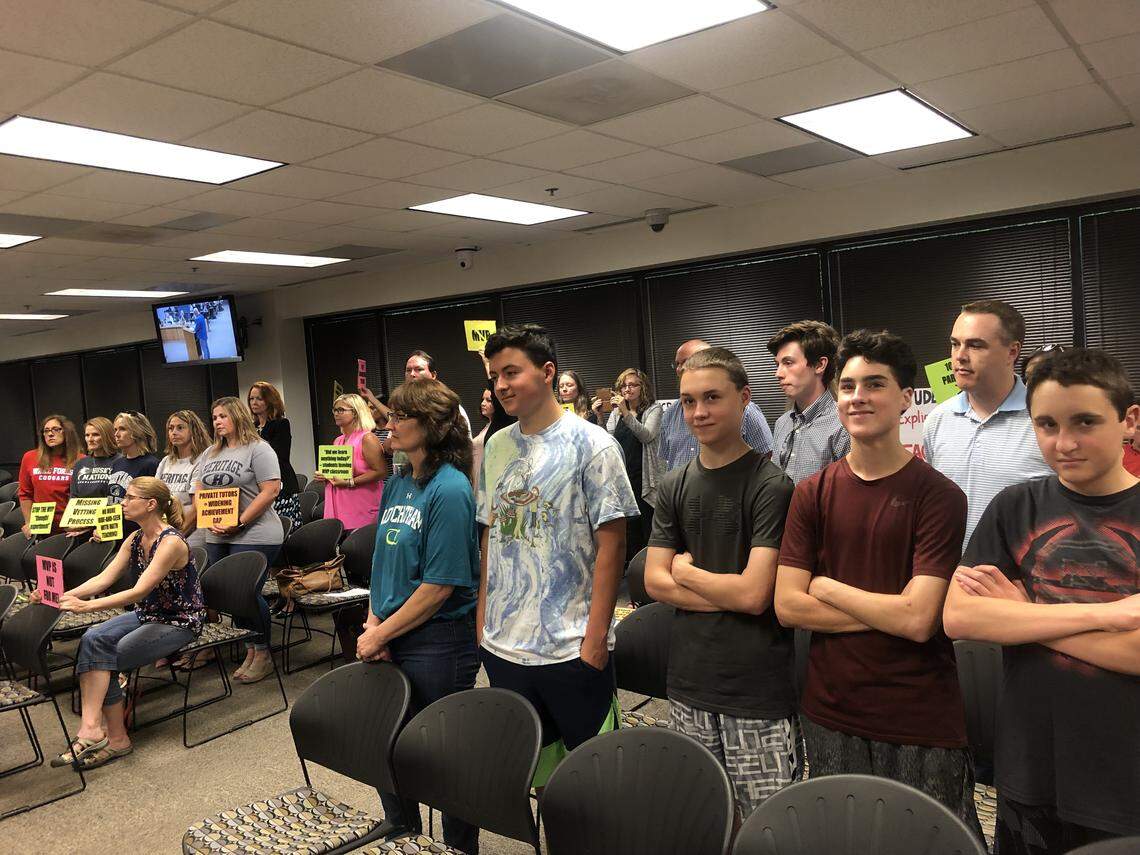 Parents and students stand up at Wake County school board meeting in Cary, N.C., on June 18, 2019 to protest the district’s use of the MVP Math Curriculum.