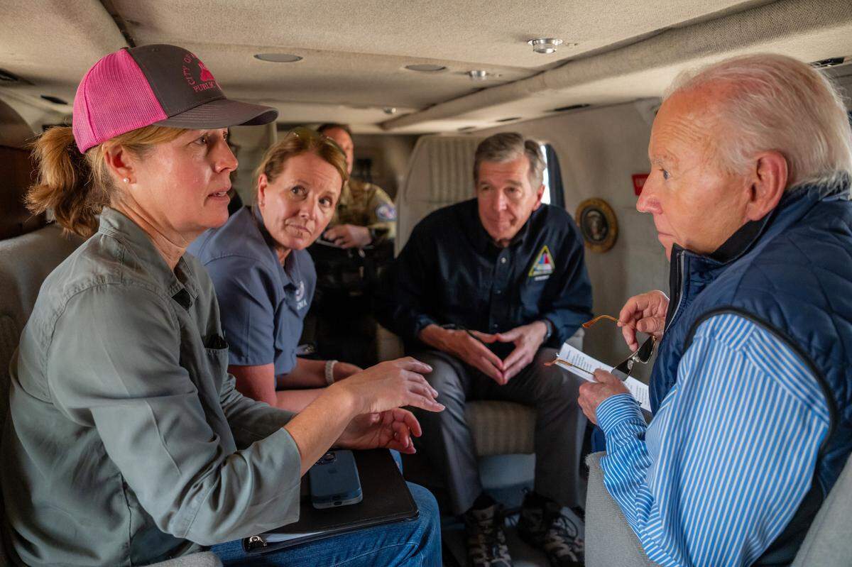 President Joe Biden speaks with Mayor Esther Manheimer of Asheville, N.C., FEMA Director Deanne Criswell and Gov. Roy Cooper (D-N.C.) during an aerial tour aboard Marine One to assess areas impacted by Hurricane Helene, Wednesday, October 2, 2024, in western North Carolina.