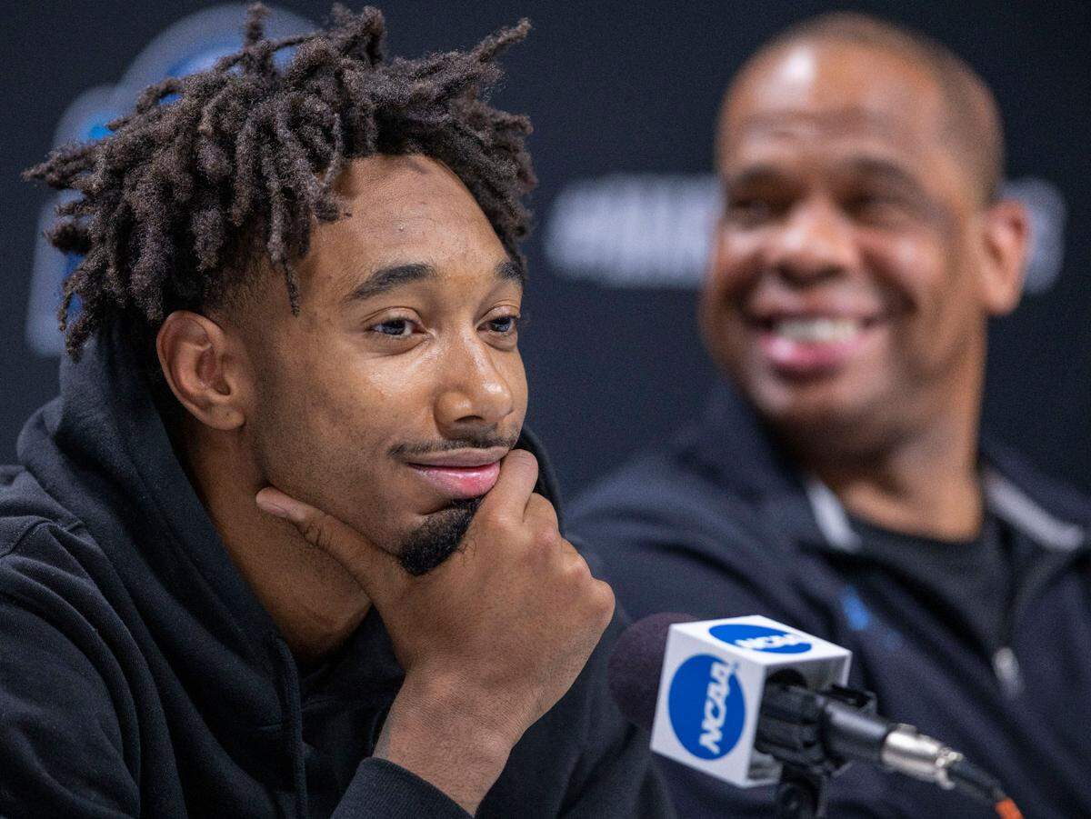 North Carolina’s Leaky Black (1) and coach Hubert Davis smile as they field questions during a media availability ahead of their NCAA East Regional final against Saint Peter’s on Saturday, March 26, 2022 at Wells Fargo Center in Philadelphia, Pa.