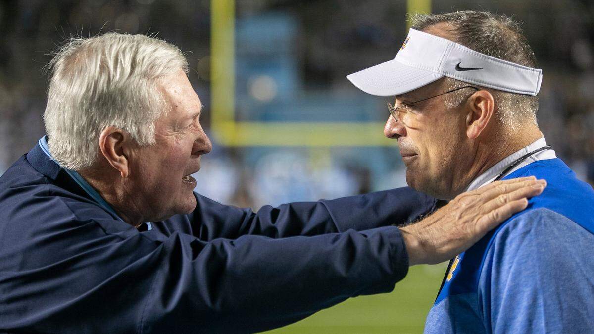 North Carolina coach Mack Brown talks with Pitt coach Pat Narduzzi prior to their game on Saturday, October 29, 2022 at Kenan Stadium in Chapel Hill, N.C.