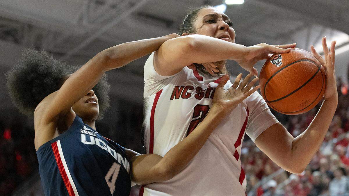 Qadence Samuels (left) fights for possession with N.C. State’s Mimi Collins in a 2023 game at Reynolds Coliseum in Raleigh, N.C. Samuels played for UConn at the time.