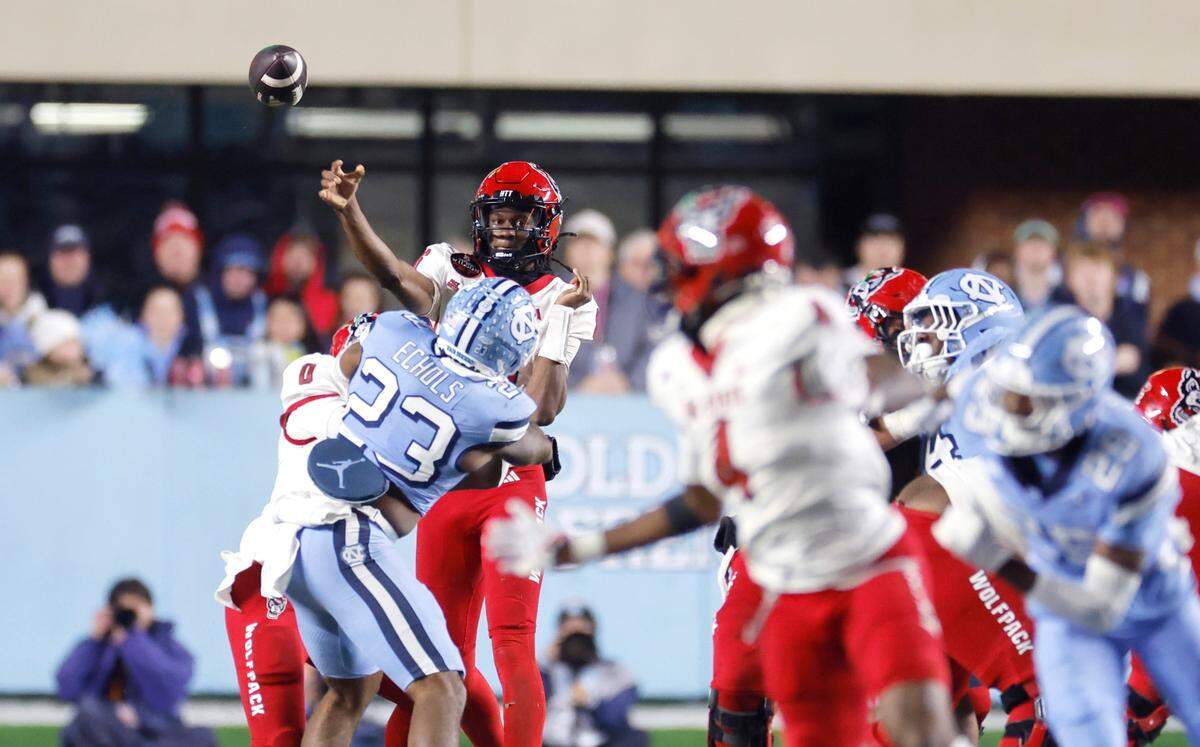 N.C. State quarterback CJ Bailey (16) passes to wide receiver Dacari Collins (4) during the second half of N.C. State’s 35-30 victory over UNC at Kenan Stadium in Chapel Hill, N.C., Saturday, Nov. 30, 2024.
