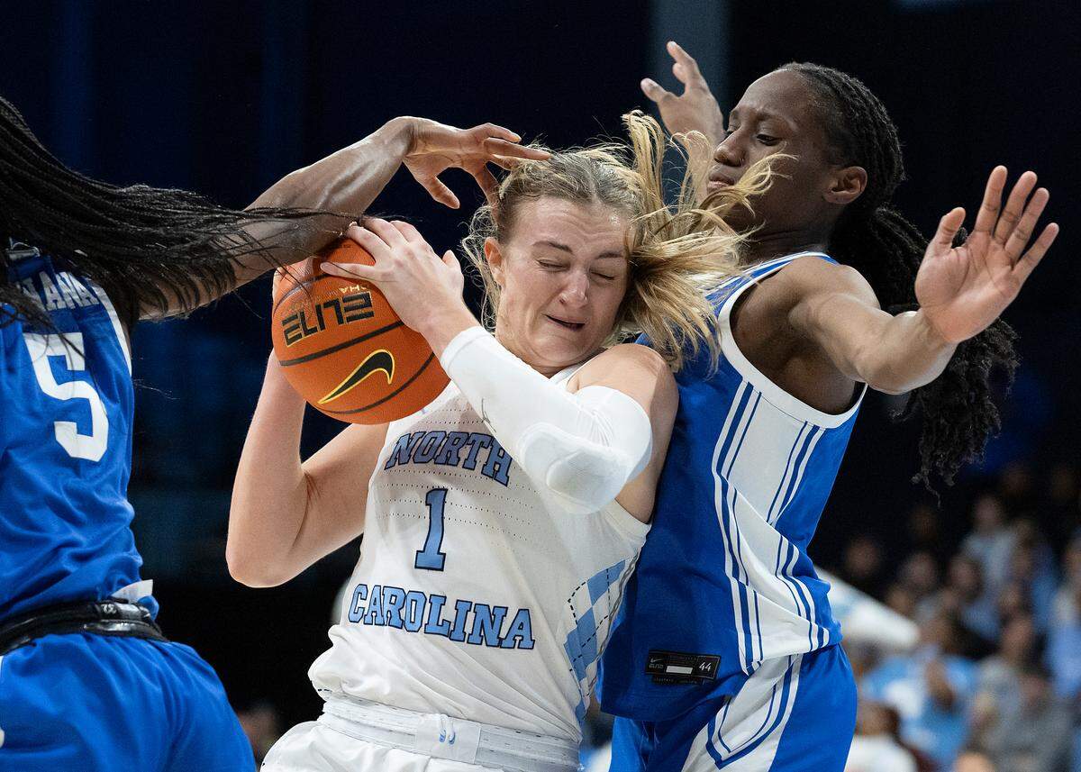 North Carolina’s Alyssa Ustby drives between Duke’s Oluchi Okananwa and Jadyn Donovan during the first half of the Tar Heels’ game on Thursday, Jan. 9, 2025, at Carmichael Arena in Chapel Hill, N.C.