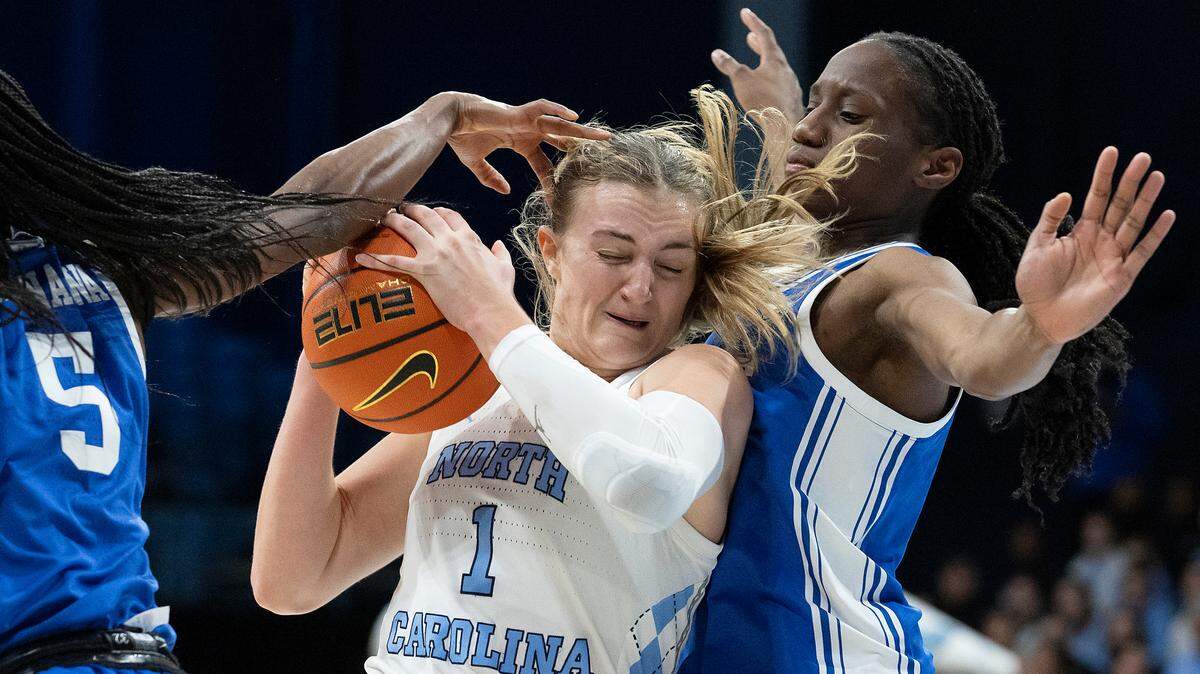 North Carolina’s Alyssa Ustby drives between Duke’s Oluchi Okananwa and Jadyn Donovan during the first half of the Tar Heels’ game on Thursday, Jan. 9, 2025, at Carmichael Arena in Chapel Hill, N.C.
