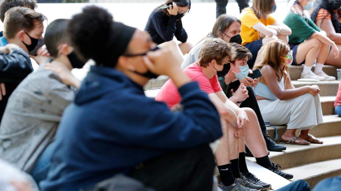 In a protest organized by Refund Raleigh, protesters sit outside city hall in downtown Raleigh, N.C., to listen to the city council meeting Tuesday, June 1, 2021. Part of the meeting was public hearing for the city’s proposed budget, which includes a $5 million increase for the police department.