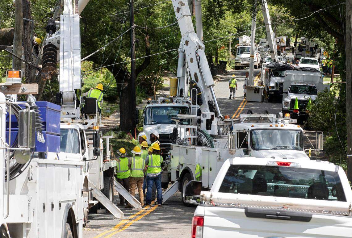 Crews work to detangle power lines near the intersection of West Markham Avenue and Washington Street on Wednesday, Aug. 16, 2023, following Tuesday evening’s strong storms in Durham, N.C.