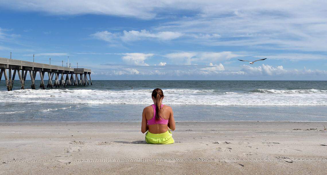 Kara Zimmerman, 26, of Wrightsville Beach, N.C. gets a final look at the Atlantic Ocean before she and her boyfriend evacuate the island in advance of Hurricane Florence  Wednesday, Sept. 12, 2018.  At 8 p.m. tonight Wrightsville Beach town officials are raising the drawbridge which connects the island to the coast until after Florence passes.