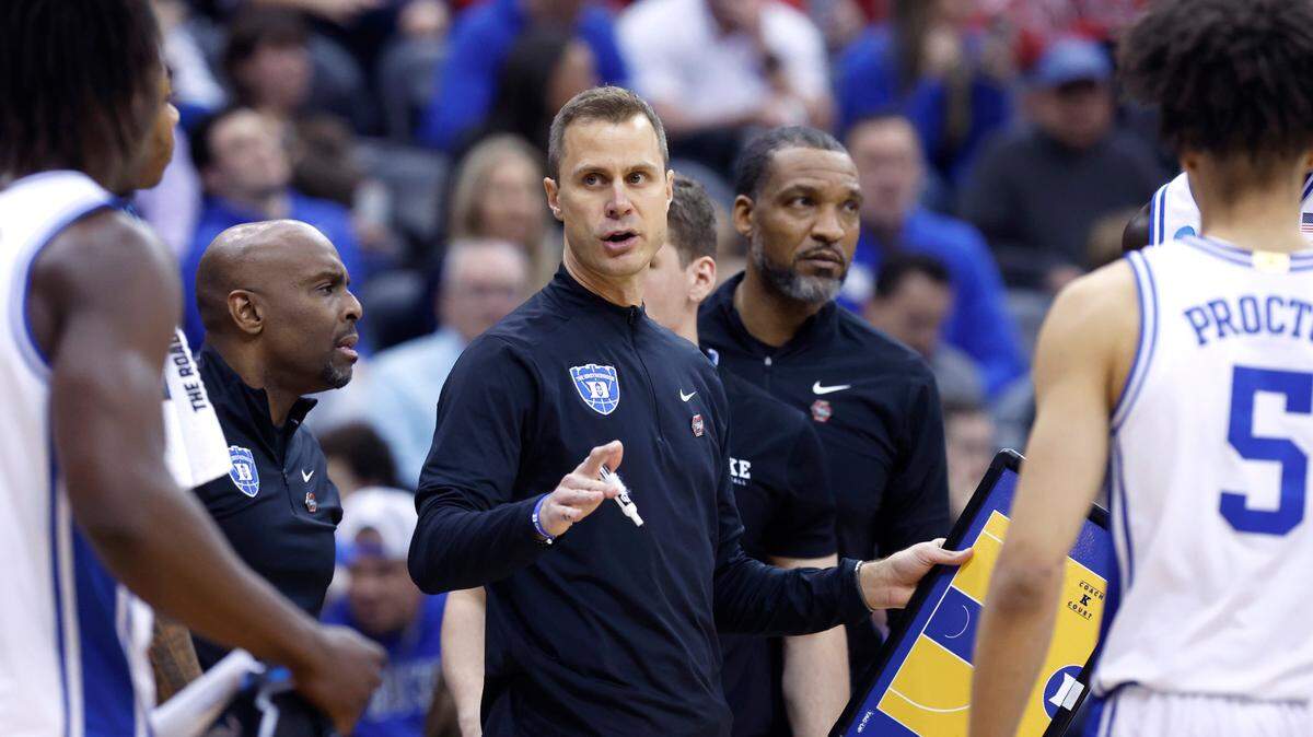 Duke head coach Jon Scheyer talks to his team during the first half of Duke’s game against Arizona in the Sweet 16 round of the 2025 Men’s NCAA Basketball Championship at the Prudential Center in Newark, N.J., Thursday, March 27, 2025. Assistant coach Emanuel Dildy stands to the left. Associate head coach Chris Carrawell stands to the right.
