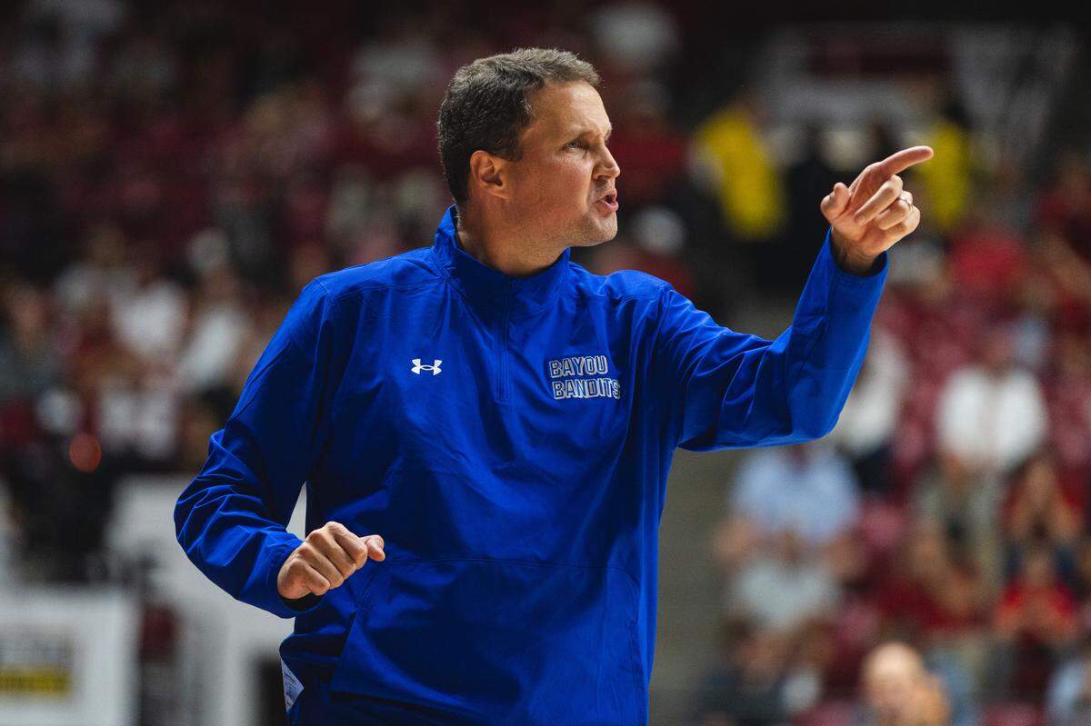 McNeese State Cowboys head coach Will Wade gives instructions to his players.