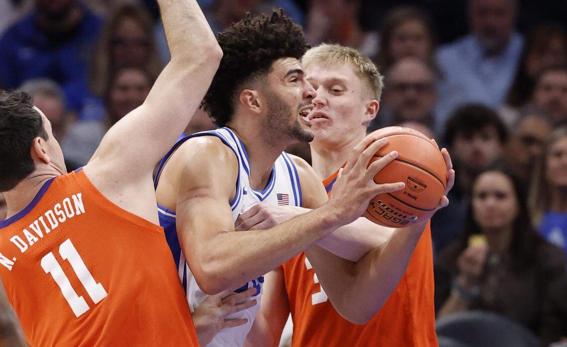 Duke’s Cameron Boozer (12) drives through Clemson's Nick Davidson (11) and Chase Thompson (3) during the first half of Duke’s game against Clemson in the semifinals of the 2026 ACC Men’s Basketball Tournament at the Spectrum Center in Charlotte, N.C., Friday, March 13, 2026.