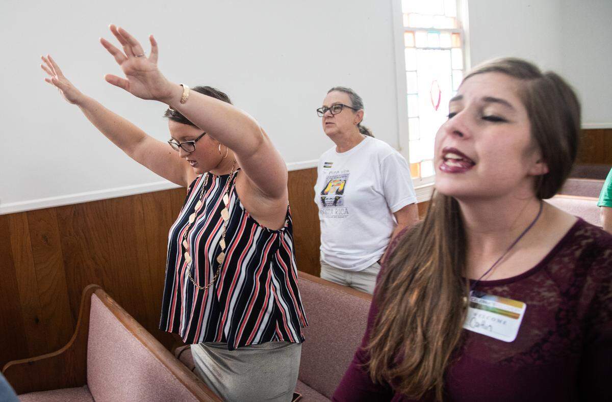 Samantha Brawley, a member of the Eastern Band of Cherokee Indians, left, takes part in an addiction recovery peer support meeting at Webster Baptist Church in Sylva last year.