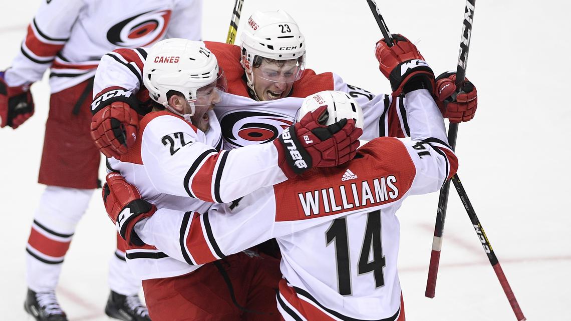 Carolina Hurricanes left wing Brock McGinn (23) celebrates his game-winning goal with right wing Justin Williams (14) and defenseman Brett Pesce (22), in double overtime of Game 7 of an NHL hockey first-round playoff series against the Washington Capitals, Wednesday, April 24, 2019, in Washington. The Hurricanes won 4-3 in double overtime.