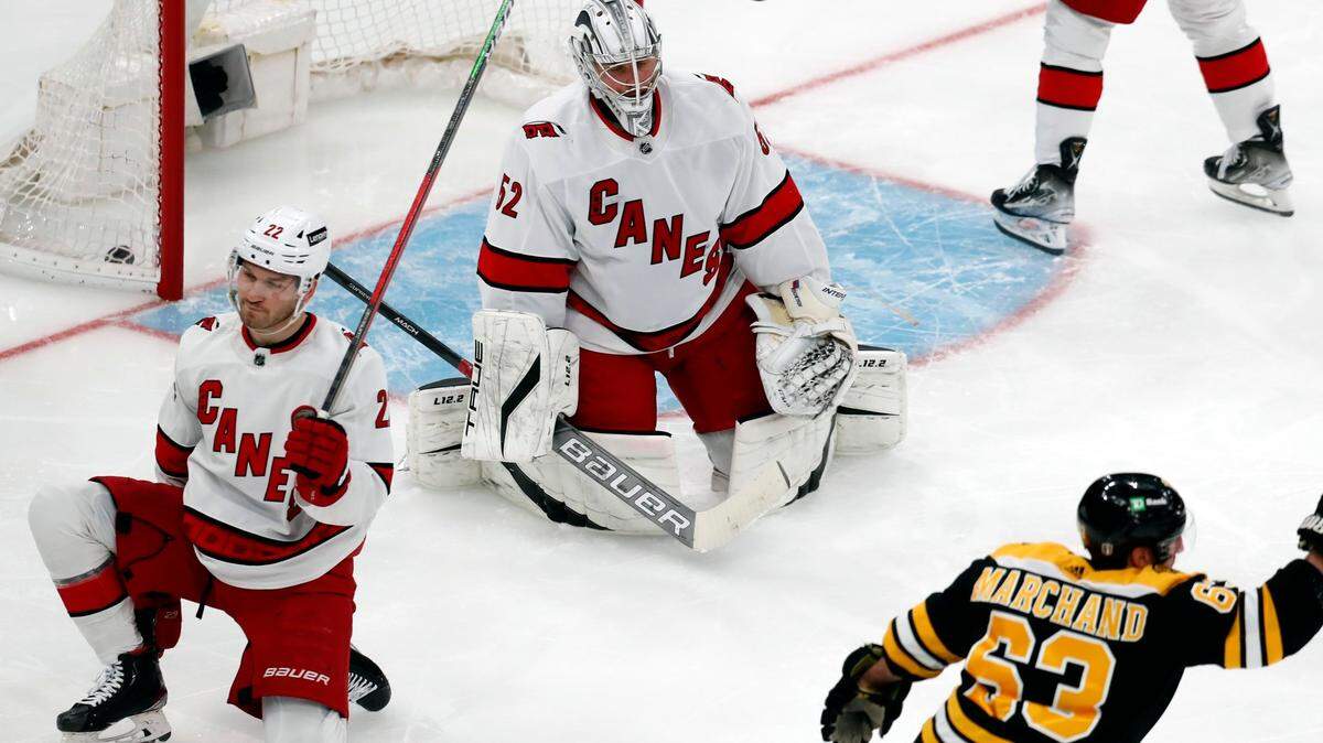 Boston Bruins’ Brad Marchand (63) celebrates his goal as Carolina Hurricanes’ Pyotr Kochetkov (52) and Brett Pesce (22) kneel on the ice during the second period of Game 3 of an NHL hockey Stanley Cup first-round playoff series, Friday, May 6, 2022, in Boston. (AP Photo/Michael Dwyer)