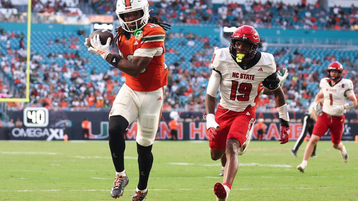Malachi Toney of the Miami Hurricanes catches a pass for a touchdown against the NC State Wolfpack during the second quarter of the game at Hard Rock Stadium on November 15, 2025 in Miami Gardens, Florida. 
