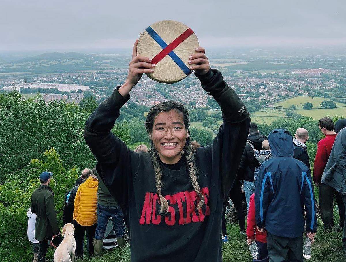 Abby Lampe, a recent graduate of NC State University, took first place in the women’s race at the Cooper’s Hill Cheese Rolling and Wake in Gloucester, England. Her advice is “Be the cheese.”