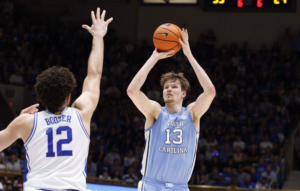 North Carolina's Henri Veesaar (13) shoots as Duke’s Cameron Boozer (12) defends during the first half of Duke’s game against UNC at Cameron Indoor Stadium in Durham, N.C., Saturday, March 7, 2026.