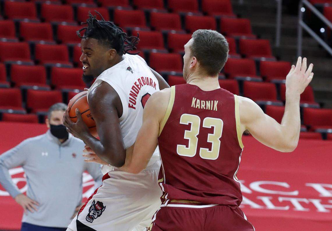 N.C. State’s D.J. Funderburk (0) brings the ball around Boston College’s James Karnik (33) during the first half of N.C. State’s game against Boston College at PNC Arena in Raleigh, N.C., Wednesday, December 30, 2020.
