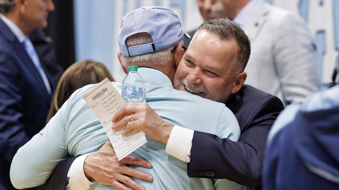 New North Carolina men’s basketball head coach Michael Malone receives a hug following an introductory press conference at the Smith Center on Tuesday, April 7, 2026, in Chapel Hill, N.C. 