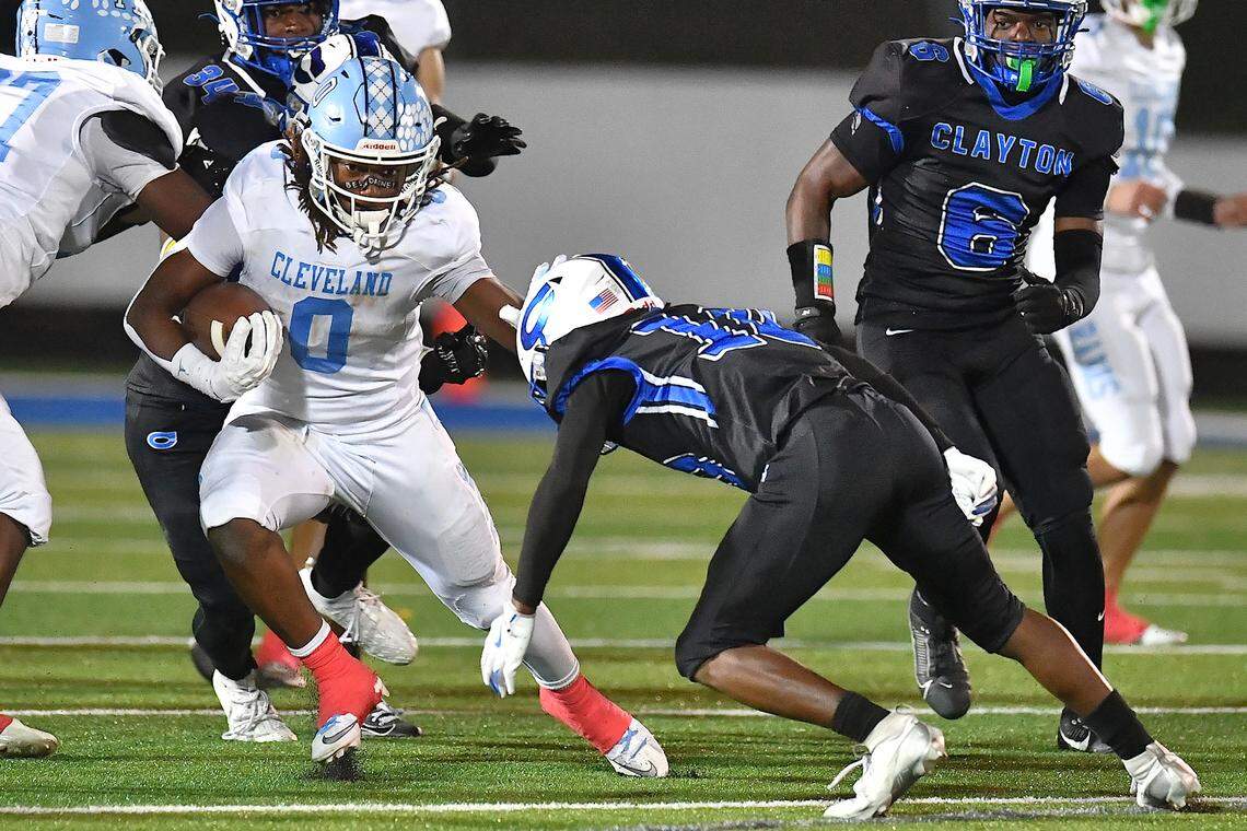 Cleveland running back Kaleb Ferrell (0) runs for yardage against Clayton's Charles Smith (10) during the second half.  The Cleveland Rams took on the Clayton Comets in a conference football game in Clayton, N.C. on October 31st in Clayton, N.C.