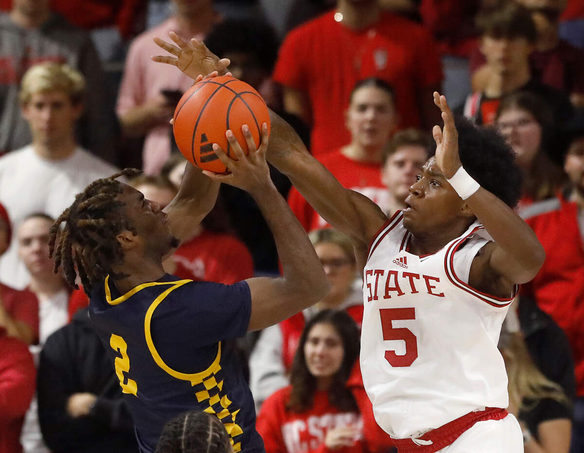 N.C. State’s Trey Parker contests a shot by Coppin State’s Toby Nnadozie during the second half of the Wolfpack’s 66-56 win on Tuesday, Dec. 10, 2024, at Reynolds Coliseum in Raleigh, N.C.